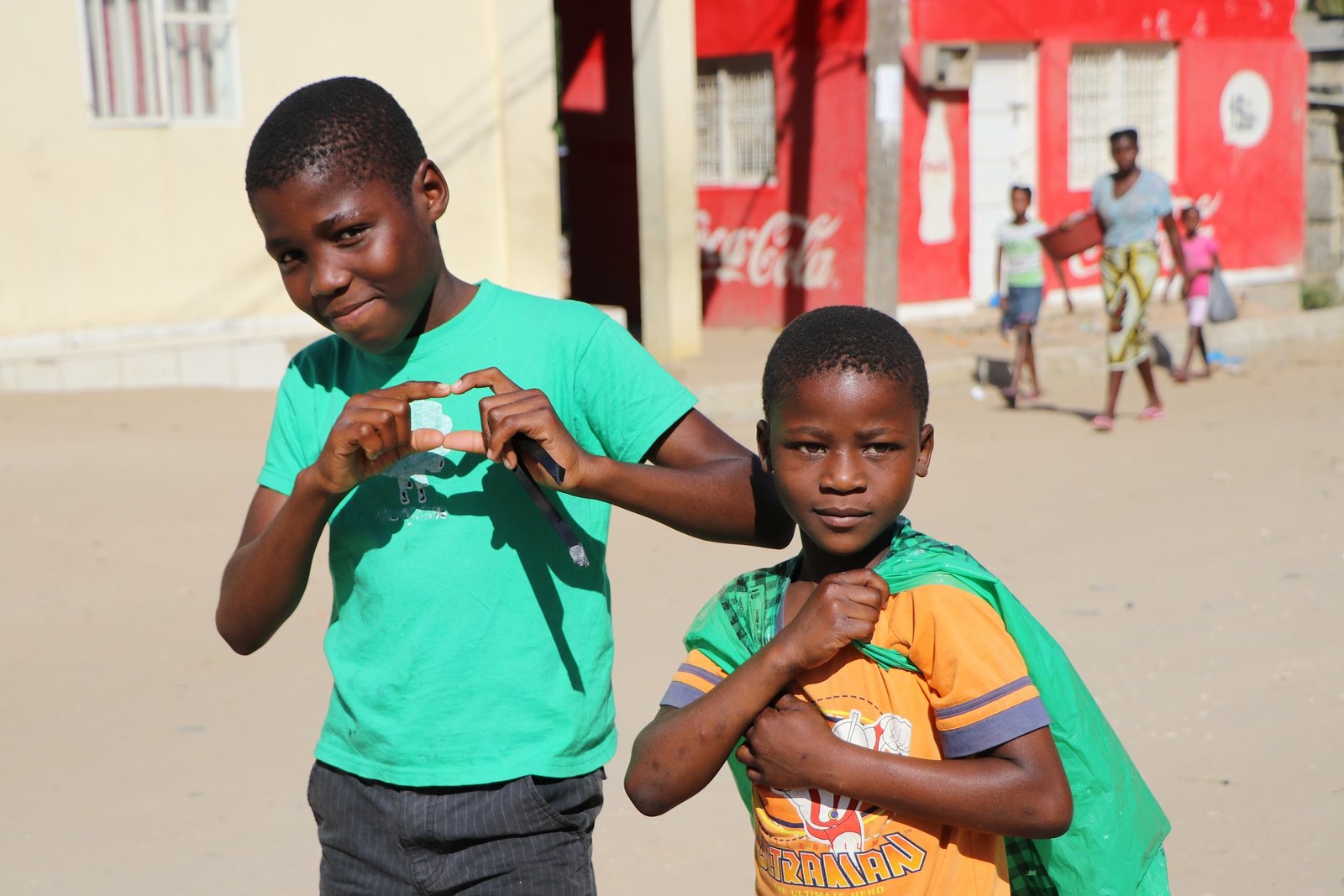 Two schoolchildren outside a classroom in a member village